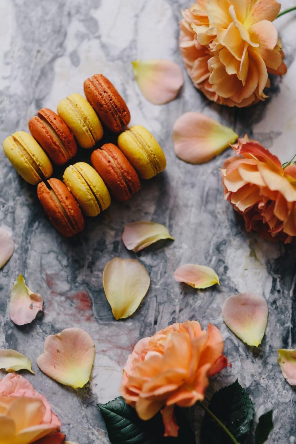 Orange and yellow macarons with flowers Orange and yellow macarons with flowers