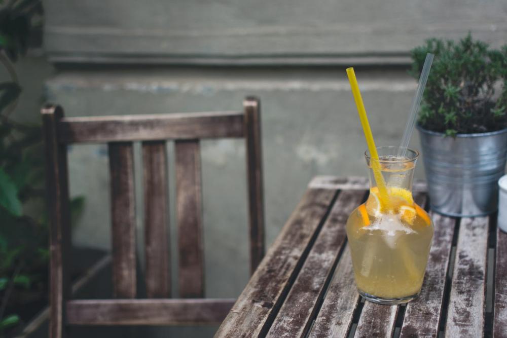 Orange lemonade at a wooden desk outside Orange lemonade at a wooden desk outside