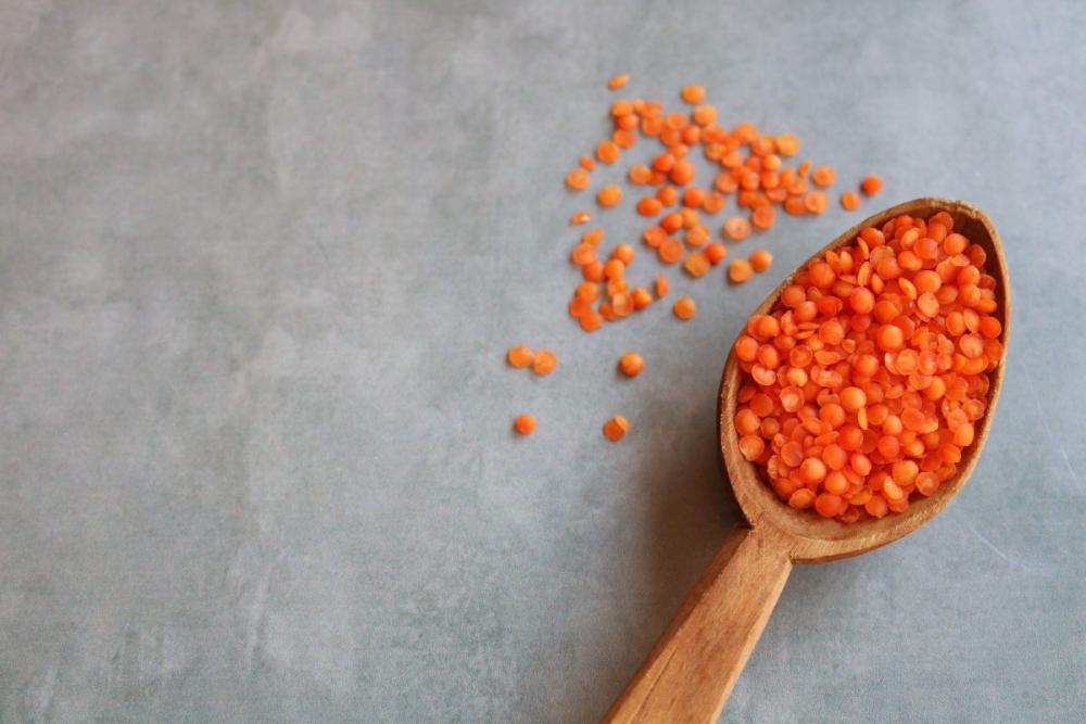 Red lentils in a wooden spoon Red lentils in a wooden spoon