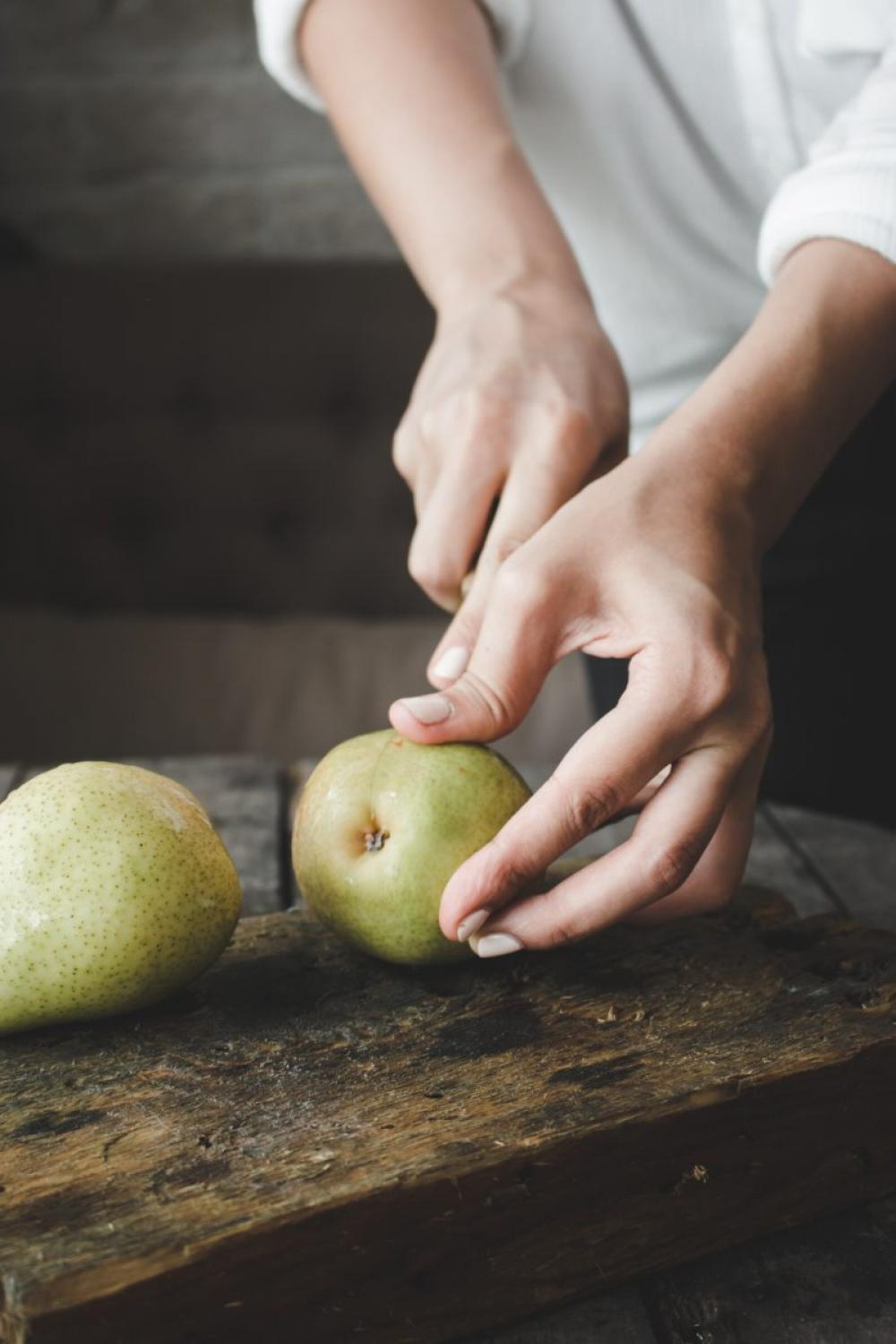 Woman cutting pear Woman cutting pear