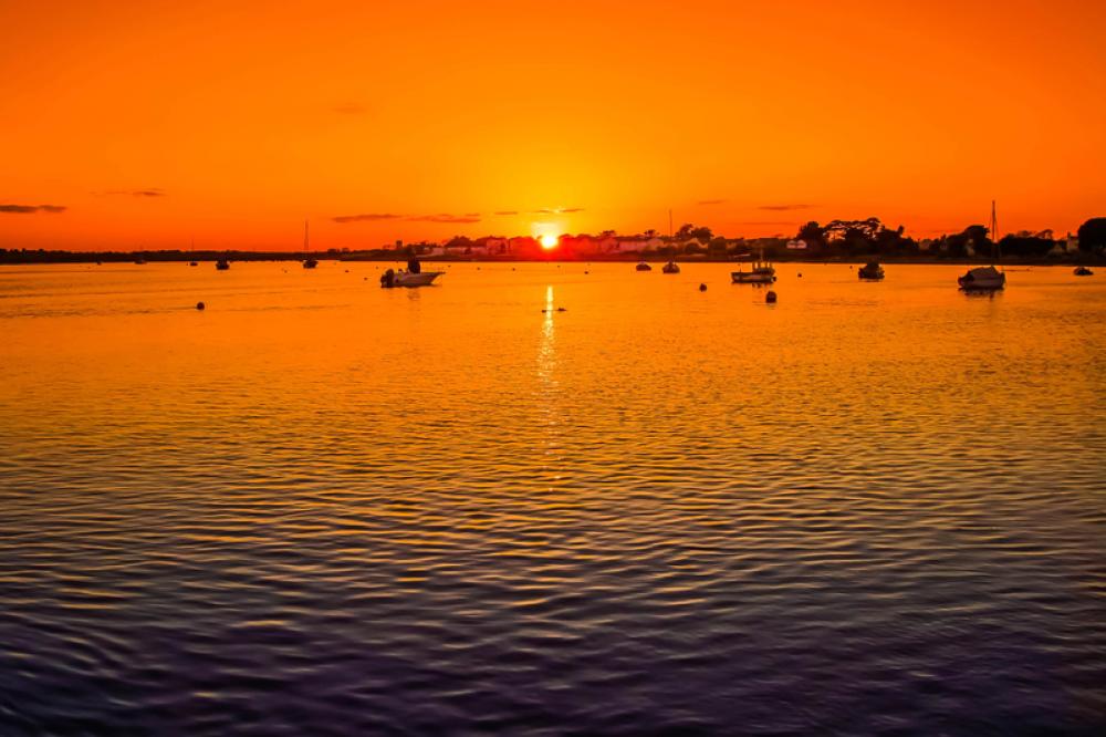 Sunset over the waters with boats at Christchurch, England free photo Sunset over the waters with boats at Christchurch, England free photo