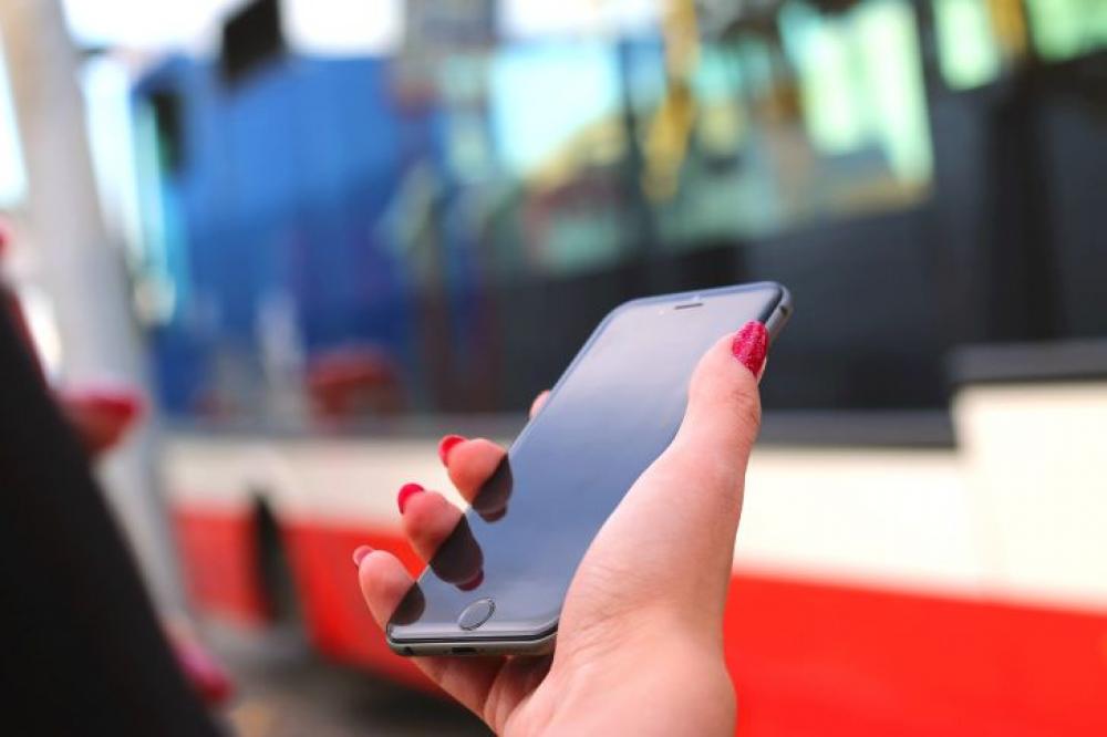 Black modern smartphone in hand woman on the street Black modern smartphone in hand woman on the street