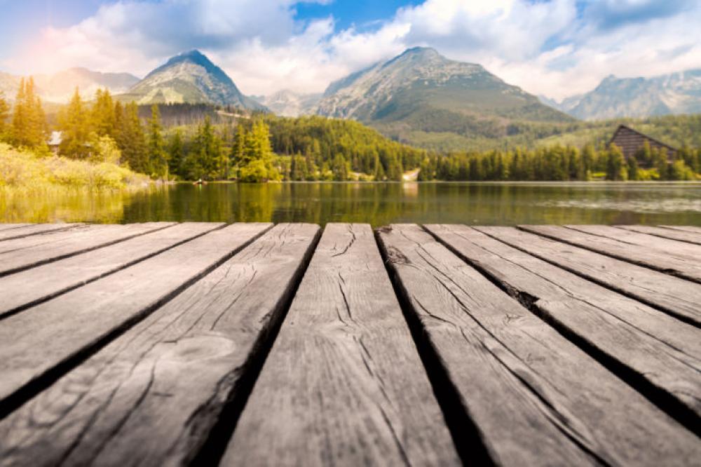 Majestic mountain lake in National Park High Tatra. Wooden table place of free space. Majestic mountain lake in National Park High Tatra. Wooden table place of free space.