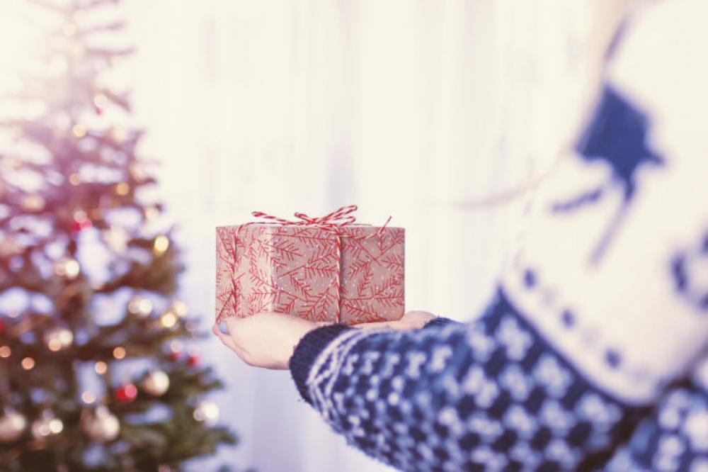 Woman’s hands hold christmas gift box. Merry Christmas Woman’s hands hold christmas gift box. Merry Christmas