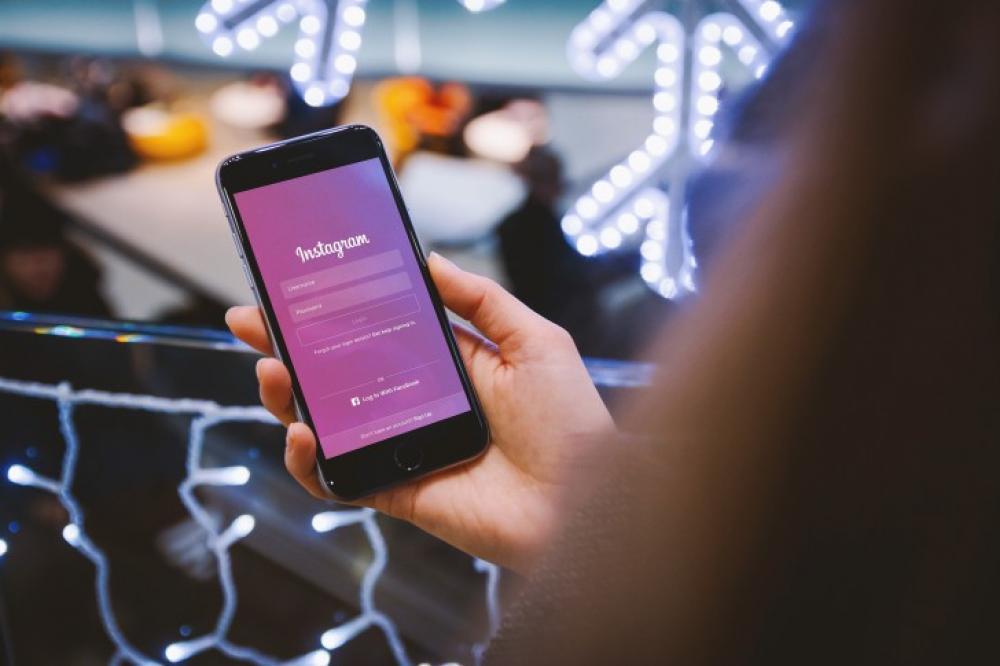 Instagram app. Woman uses her smartphone Instagram app. Woman uses her smartphone