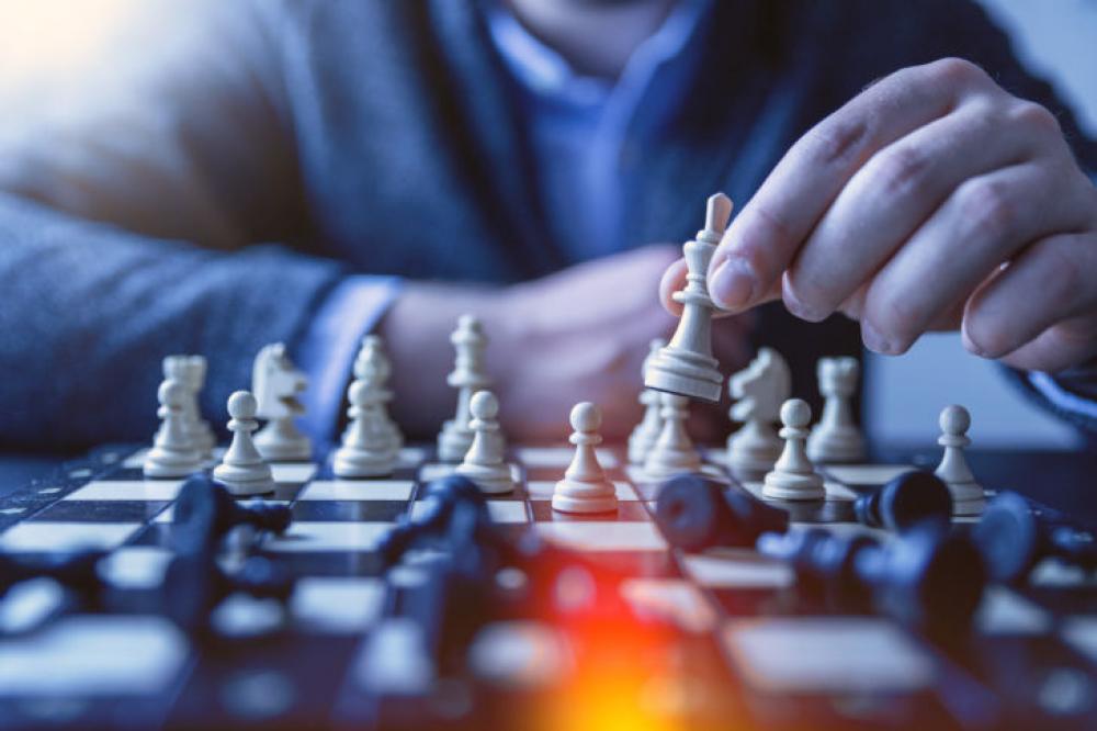 Chess financial business strategy concept. Team leader holding chess piece. Chess financial business strategy concept. Team leader holding chess piece.
