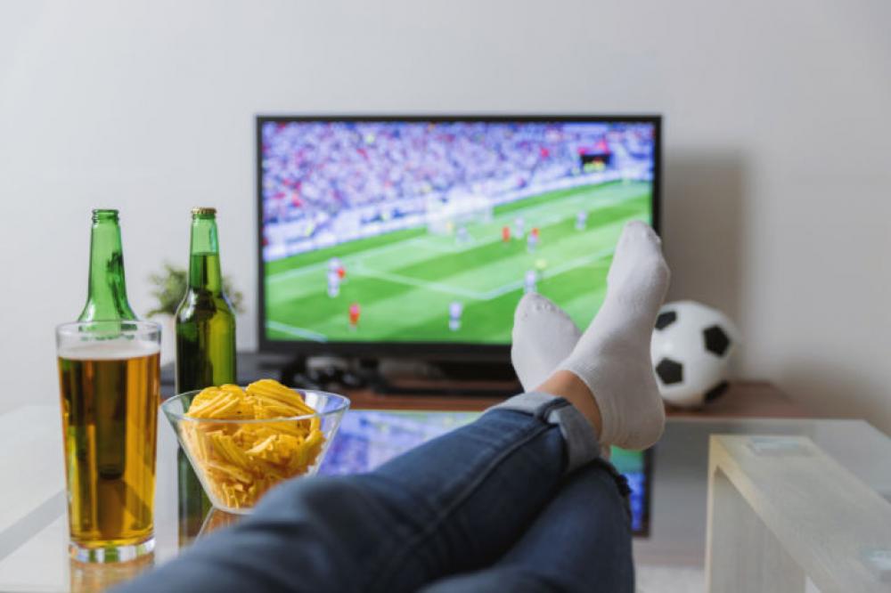 Watching A Soccer Match On Tv With The Feet On The Table Image Finder
