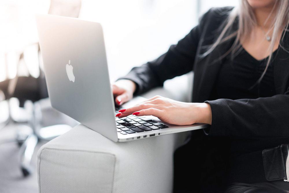 Business Woman Using Her Laptop on a Sofa Business Woman Using Her Laptop on a Sofa