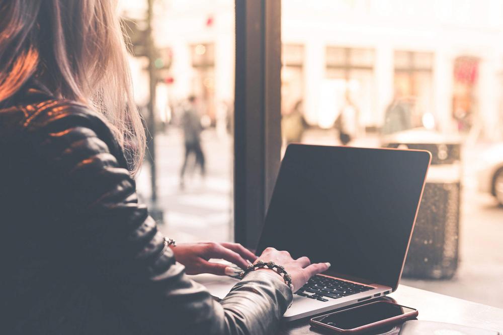 Digital Nomad Millenial Woman Working Remotely from Café Digital Nomad Millenial Woman Working Remotely from Café