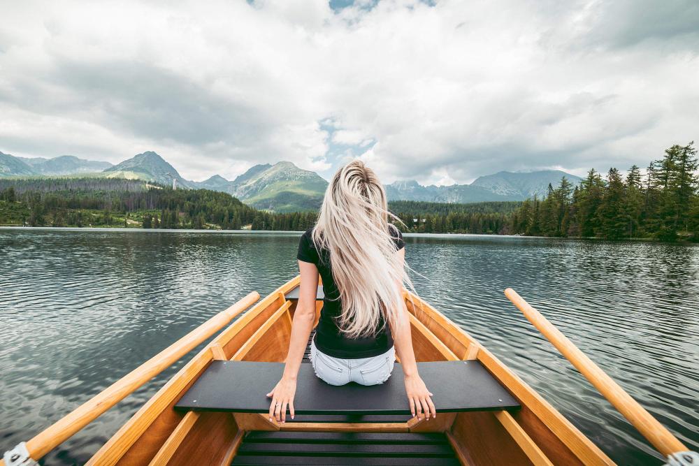 Young Blonde Woman Enjoying a Rowing Boat Young Blonde Woman Enjoying a Rowing Boat