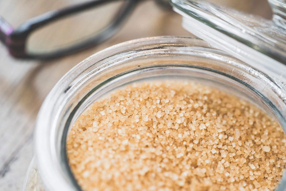 Glass Bowl with Brown Cane Sugar Close Up Glass Bowl with Brown Cane Sugar Close Up