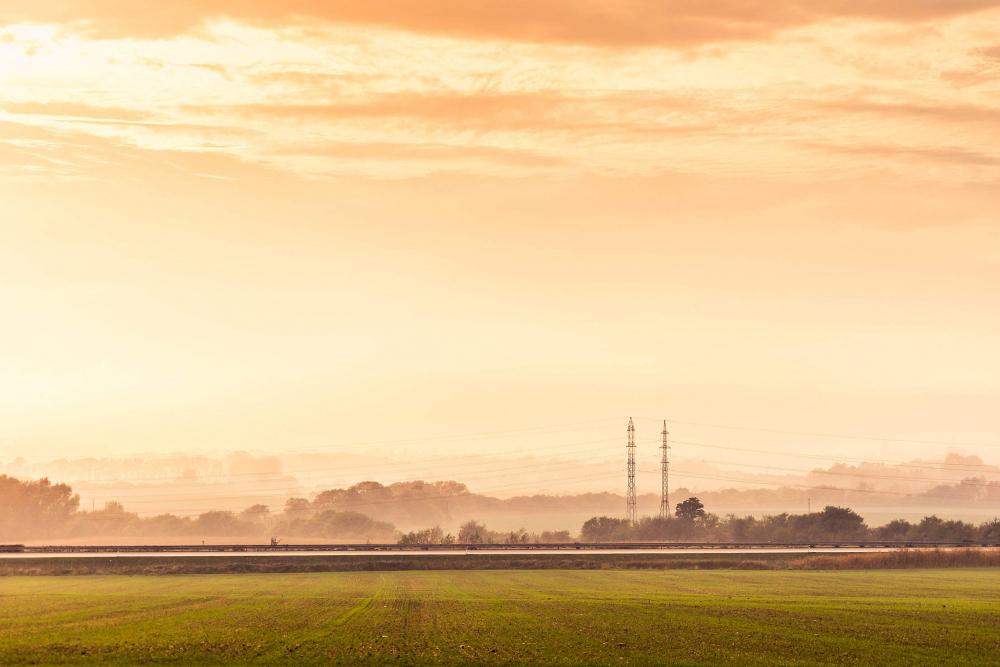 Highway Road and Electricity Pylons Foggy Golden Hour Highway Road and Electricity Pylons Foggy Golden Hour