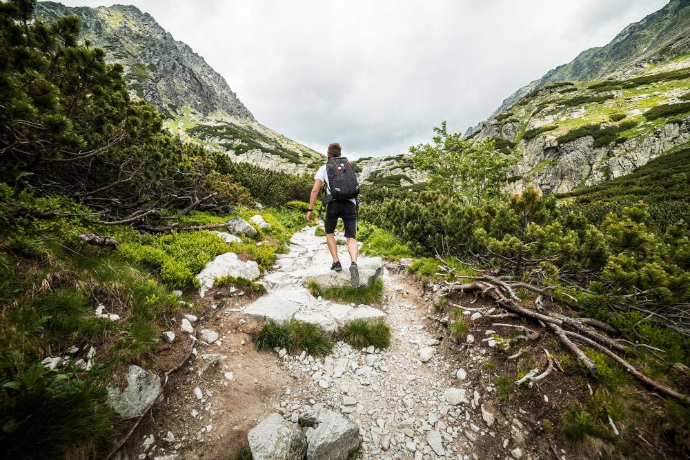 Man Hiking Alone in Mountains Man Hiking Alone in Mountains