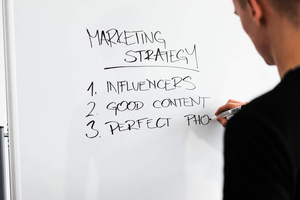 Marketing Expert Writing New Marketing Strategy on Whiteboard Marketing Expert Writing New Marketing Strategy on Whiteboard