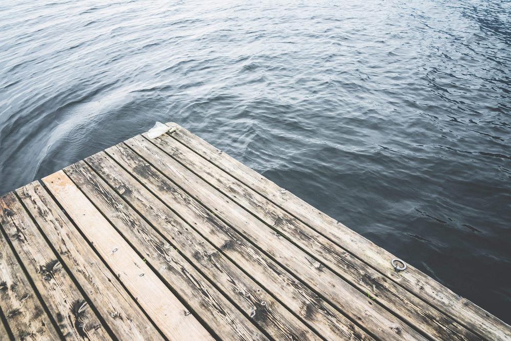 Minimalistic Shot of a Wooden Pier on a Lake Minimalistic Shot of a Wooden Pier on a Lake