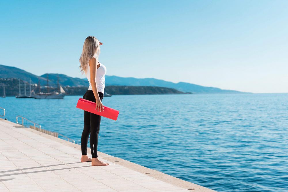 Healthy Woman Preparing for her Morning Yoga Stretching Workout Healthy Woman Preparing for her Morning Yoga Stretching Workout