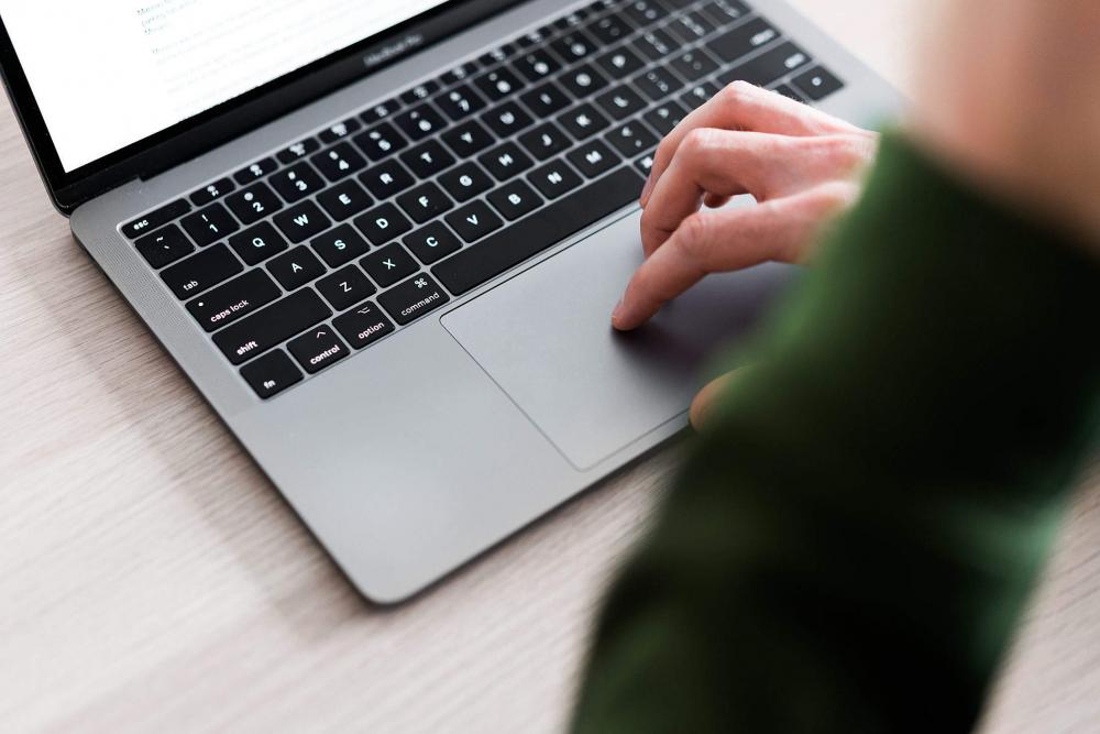 man-using-touchpad-on-his-laptop-image-finder