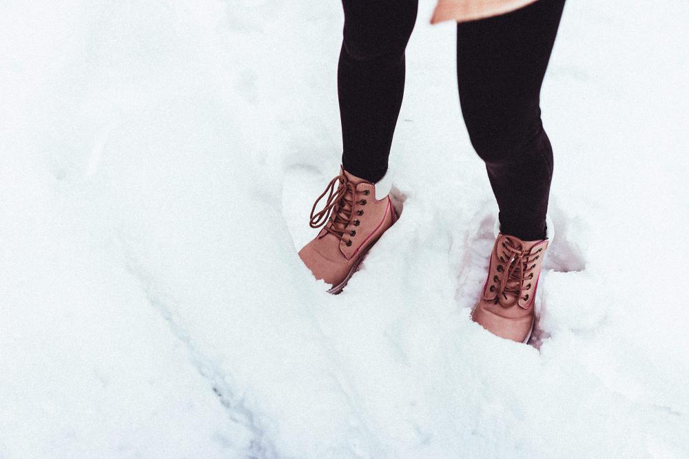 Young Woman in Winter Shoes in Snow Young Woman in Winter Shoes in Snow