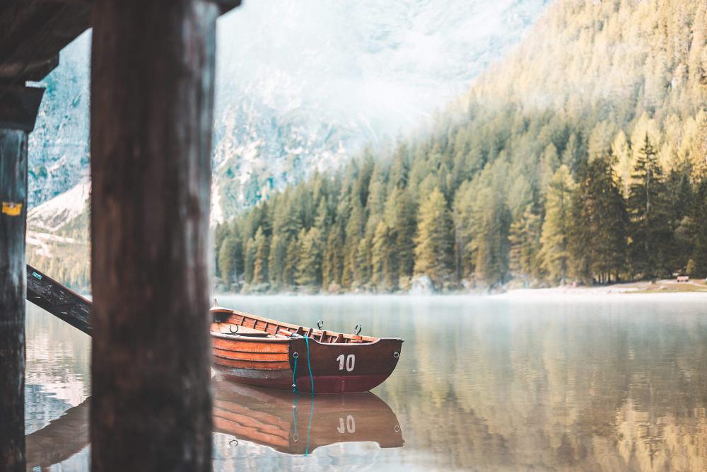 Wooden Rowing Boat on a Lake in the Morning Wooden Rowing Boat on a Lake in the Morning