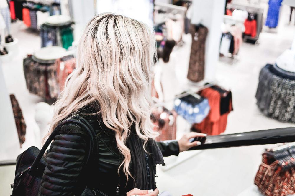 Young Blonde Girl Shopping at the Clothing Store Young Blonde Girl Shopping at the Clothing Store