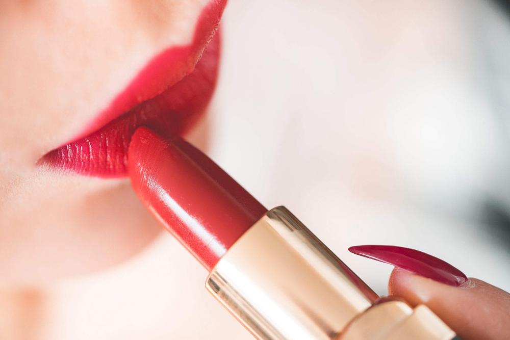 Young Woman Applying Red Lipstick Young Woman Applying Red Lipstick