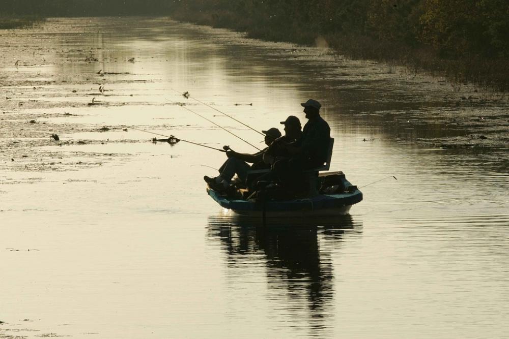 Boat From Water Glassy Against Silhouette Men Boat From Water Glassy Against Silhouette Men