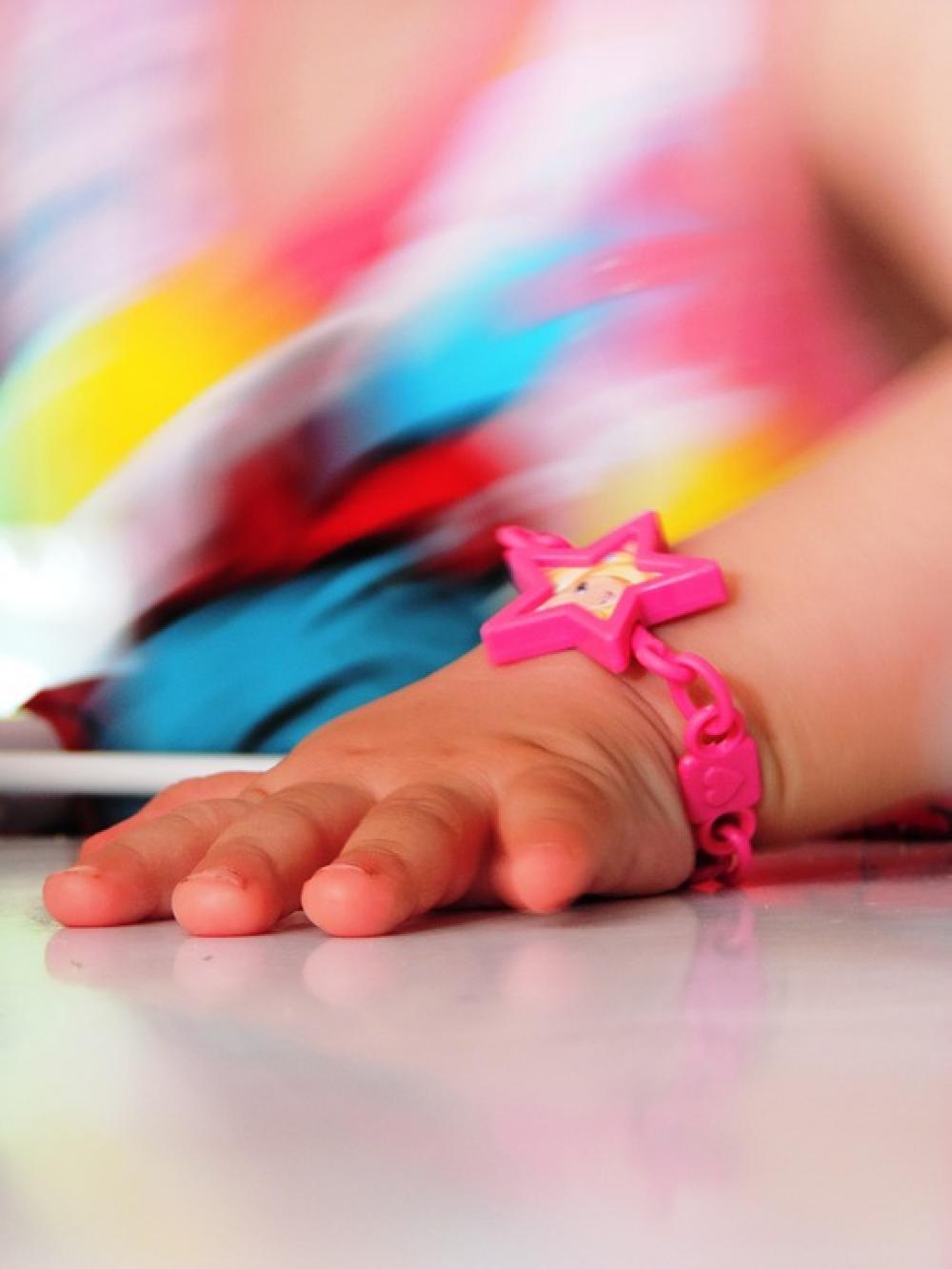 Child'S Hand A Children'S Toy Bracelet Child'S Hand A Children'S Toy Bracelet