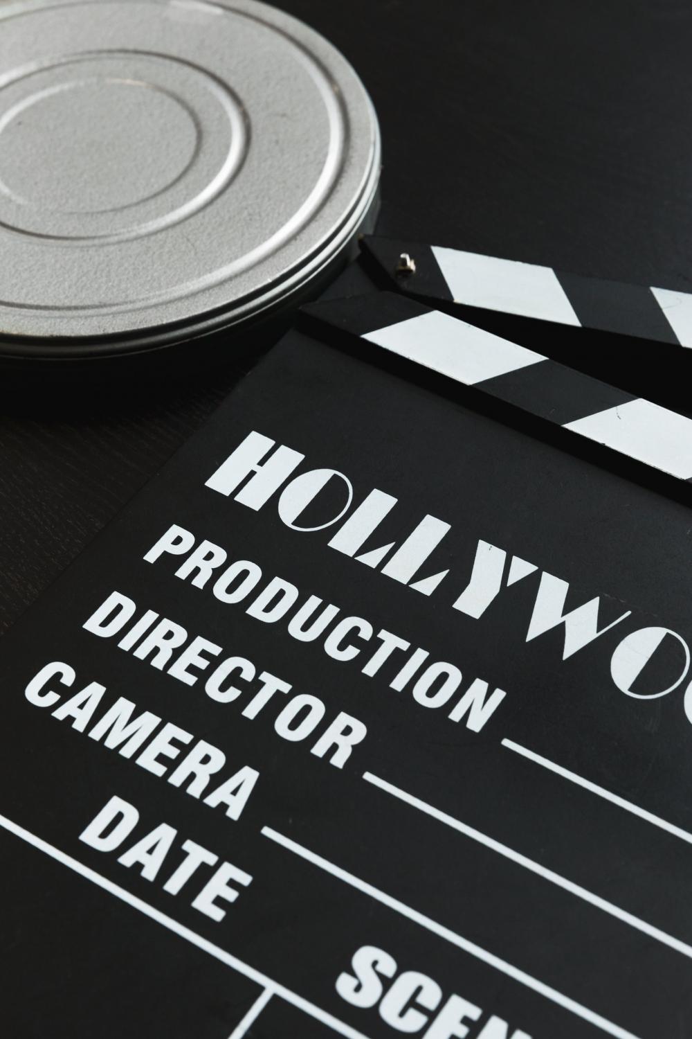 A Silver Film Reel Canister And A Movie Clapper Board Photo A Silver Film Reel Canister And A Movie Clapper Board Photo