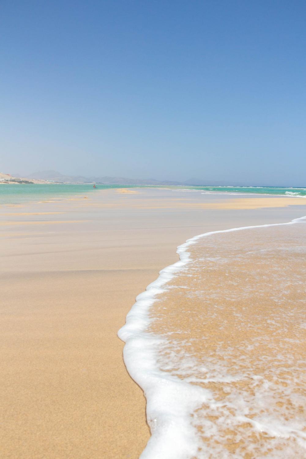 Clear Blue Water Crawls Over The White Sandy Beach Photo Clear Blue Water Crawls Over The White Sandy Beach Photo