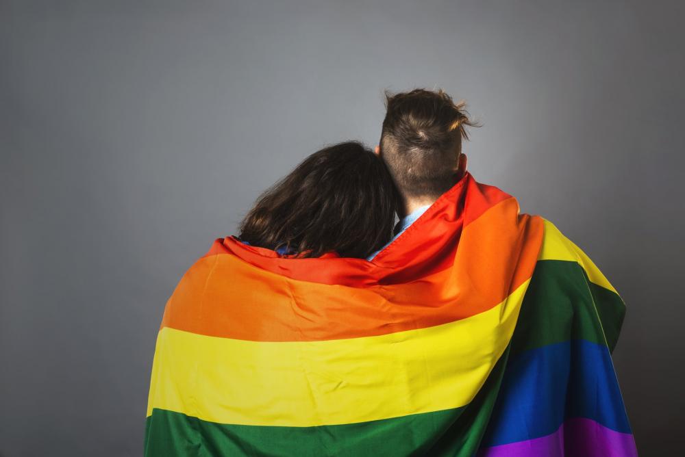 Couple Wrapped In Pride Flag Photo Couple Wrapped In Pride Flag Photo
