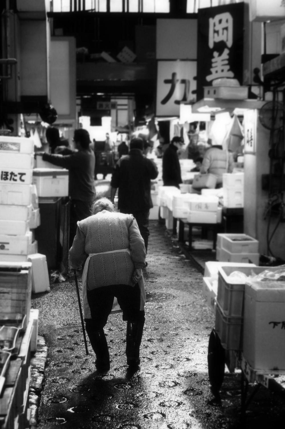Elder Walking Through Market Photo Elder Walking Through Market Photo