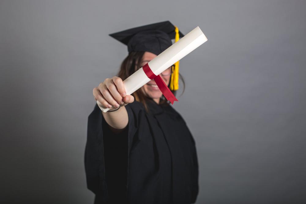 Female Grad Student Holding Out Diploma Photo Female Grad Student Holding Out Diploma Photo