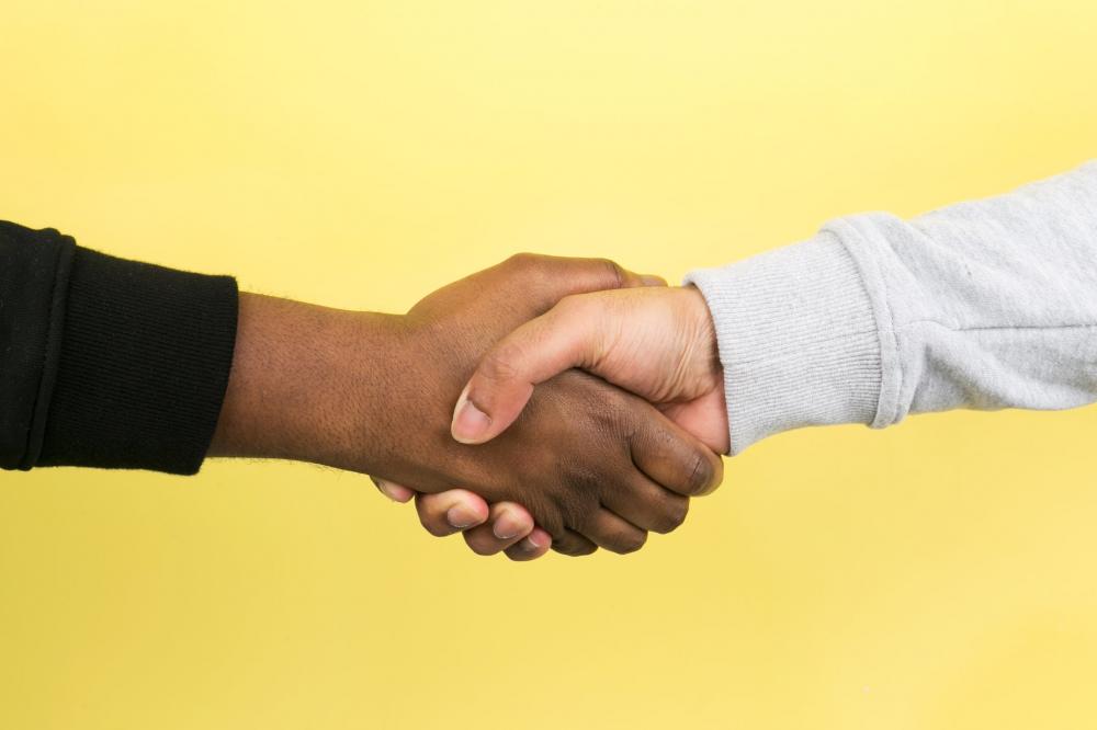 Hand Shake On Yellow Photo Hand Shake On Yellow Photo