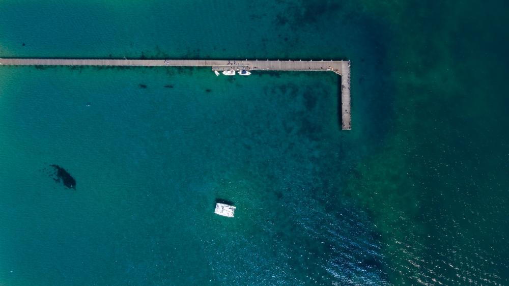 Long Wooden Pier On Blue Ocean Photo Long Wooden Pier On Blue Ocean Photo