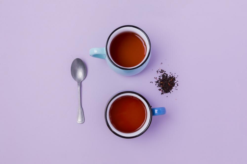 Loose Leaf Tea Brewed On Purple Photo Loose Leaf Tea Brewed On Purple Photo