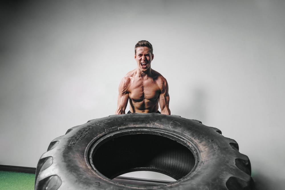 Man Lifts Tire Exercise Photo Man Lifts Tire Exercise Photo