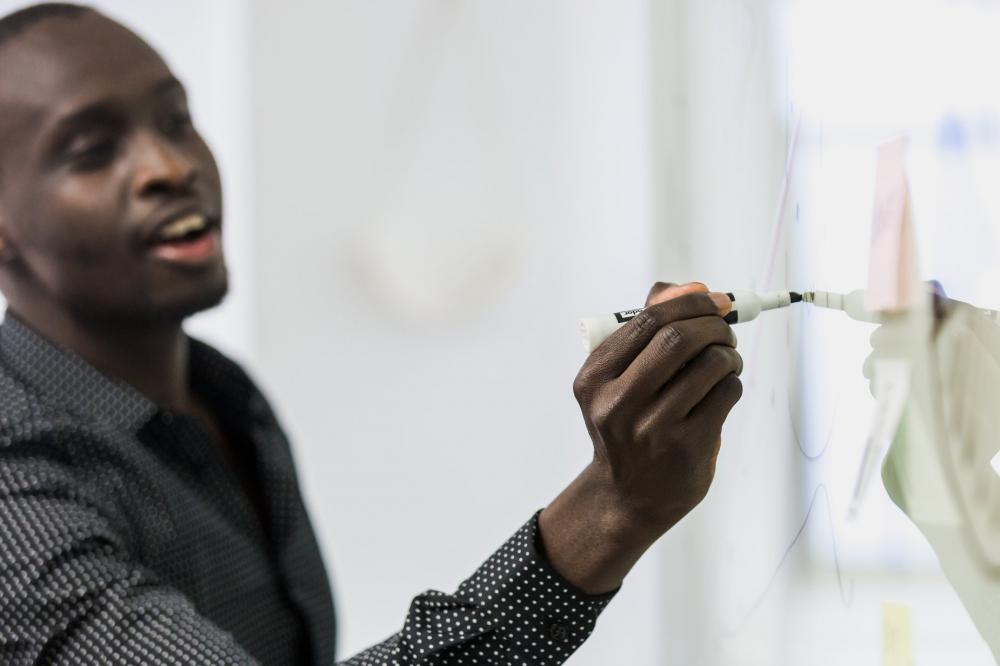 Man Writes On Whiteboard Photo Man Writes On Whiteboard Photo