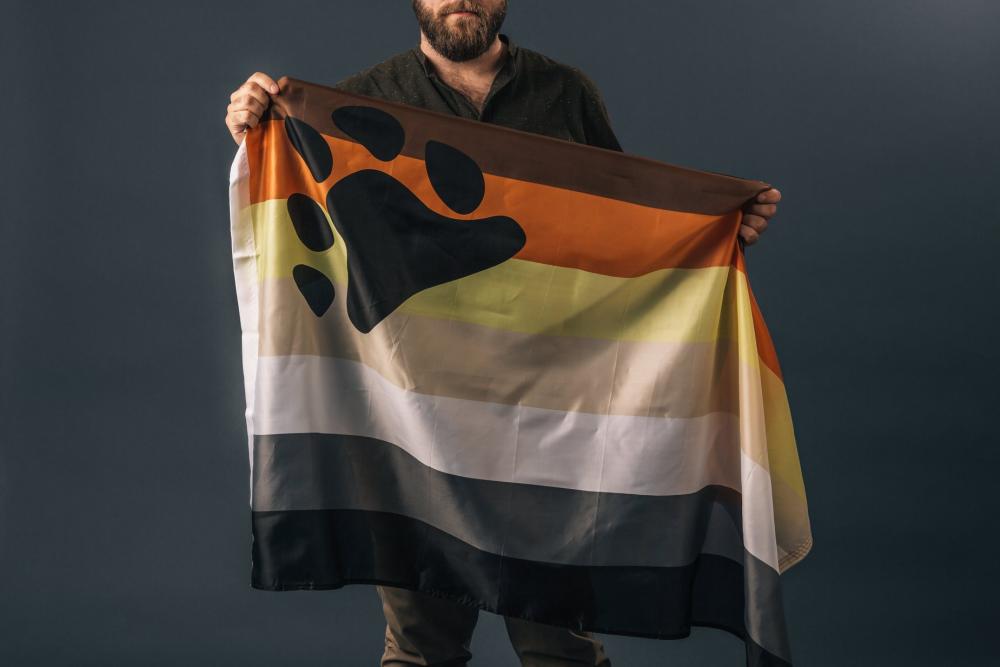 Portrait Of A Man Holding Bear Pride Flag Photo Portrait Of A Man Holding Bear Pride Flag Photo