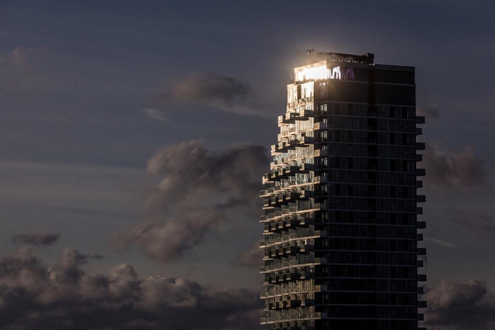 Sun Glinting Off Top Of Condo Tower Photo Sun Glinting Off Top Of Condo Tower Photo