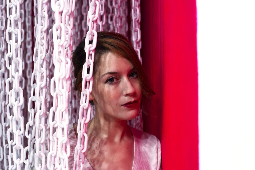 Woman Brushing Aside A Curtain Of White Chains Photo Woman Brushing Aside A Curtain Of White Chains Photo