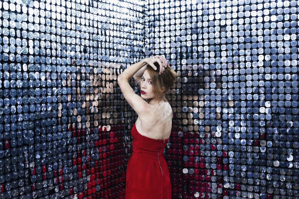 Woman In Red Dress Rests Elbows Against Wall Of Mirrors Photo Woman In Red Dress Rests Elbows Against Wall Of Mirrors Photo