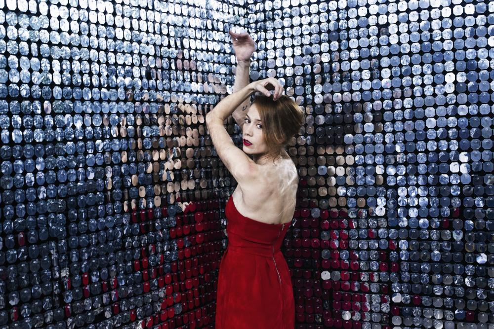 Woman In Red Dress Stretches Out Arms Against A Wall Of Mirrors Photo Woman In Red Dress Stretches Out Arms Against A Wall Of Mirrors Photo