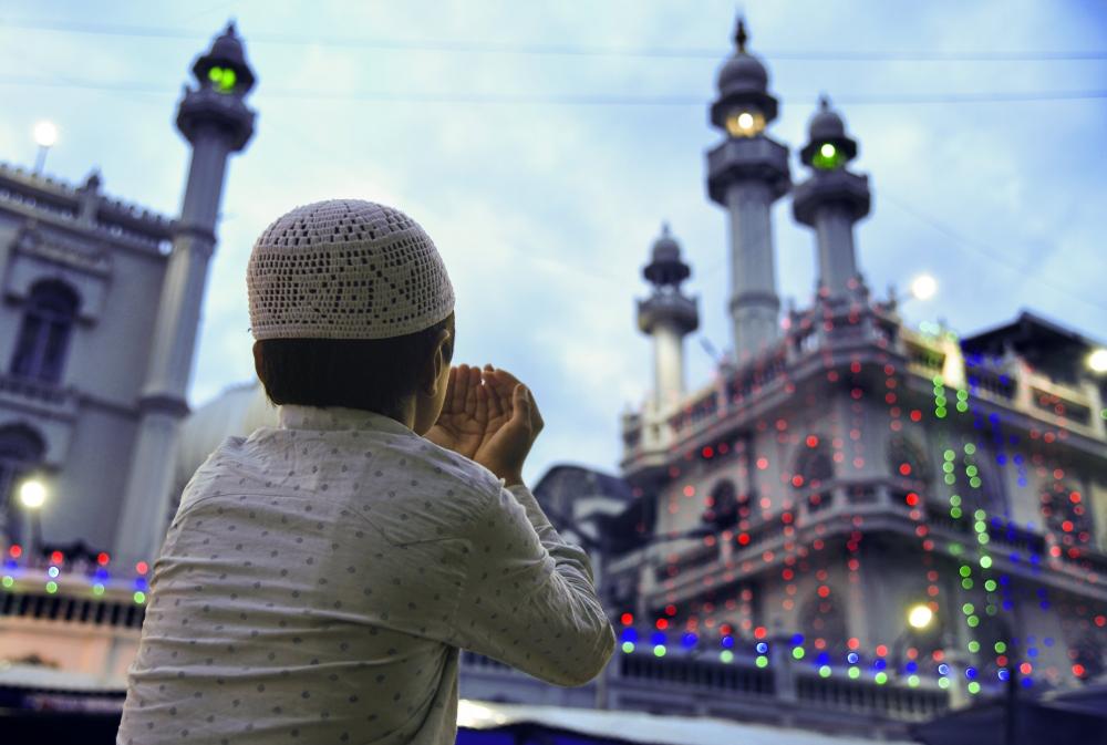Young Boy Holds Hands Up Outside Mosque Photo Young Boy Holds Hands Up Outside Mosque Photo