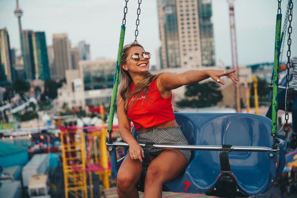 Young Woman Smiling On Swing Ride Photo Young Woman Smiling On Swing Ride Photo