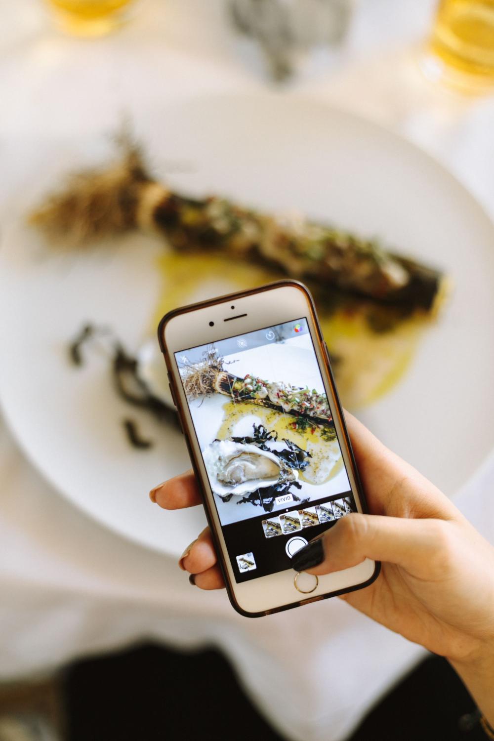 Young Woman Snaps Photo Of Food Photo Young Woman Snaps Photo Of Food Photo
