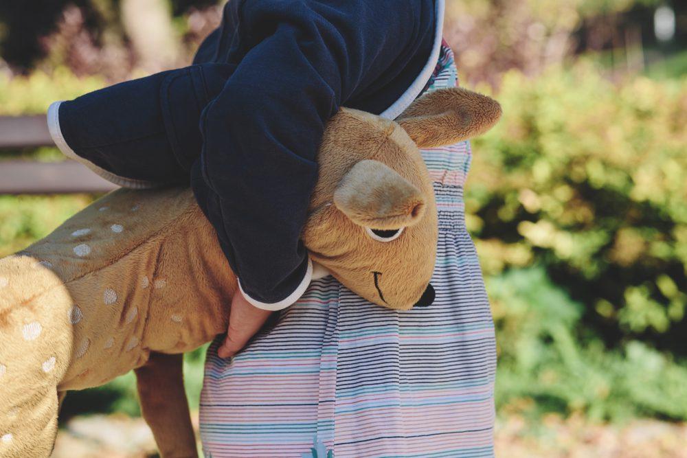 A girl holding plush Bambi A girl holding plush Bambi