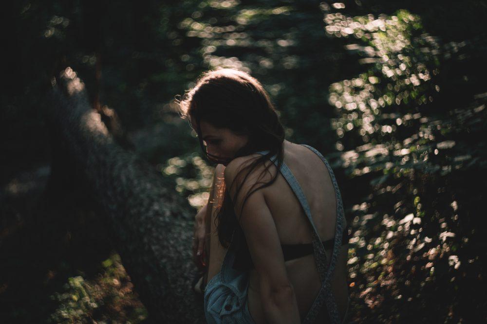 Girl sitting on a tree trunk Girl sitting on a tree trunk