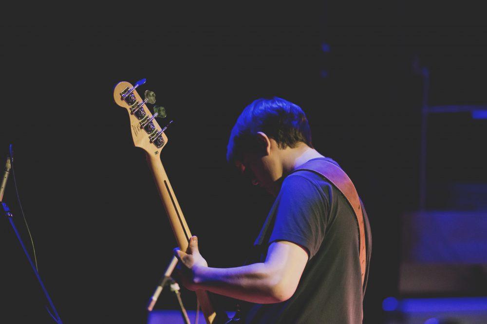 Man playing bass guitar Man playing bass guitar