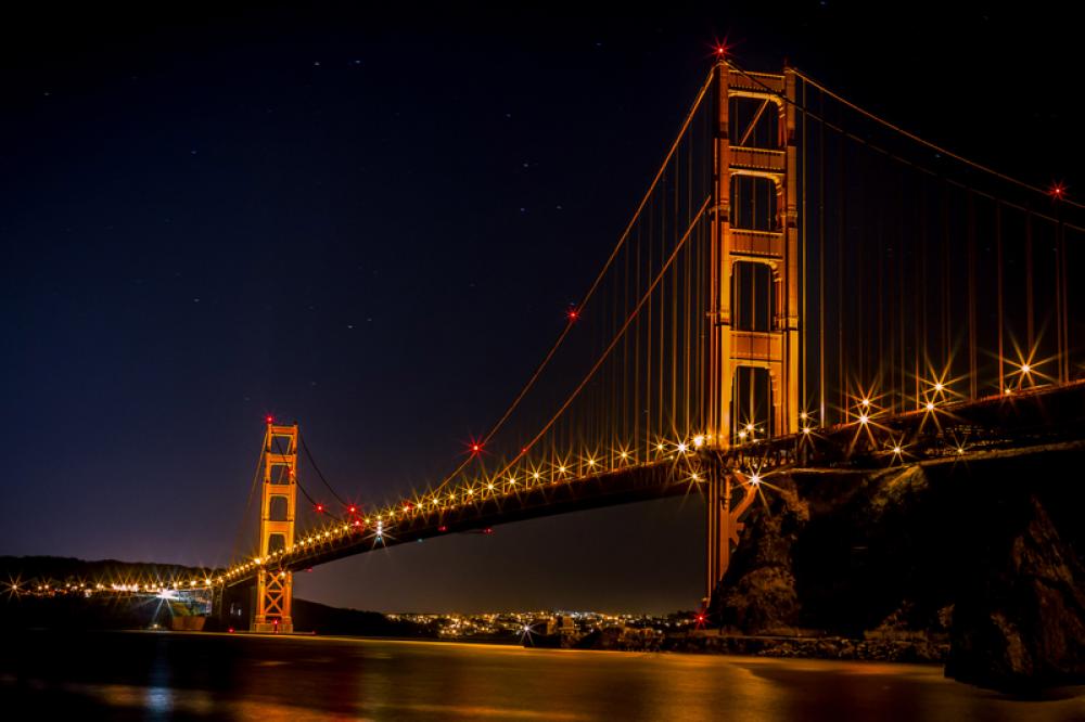 Golden Gate Bridge over the bay at night illuminated in Gold in San Francisco, California free photo Golden Gate Bridge over the bay at night illuminated in Gold in San Francisco, California free photo