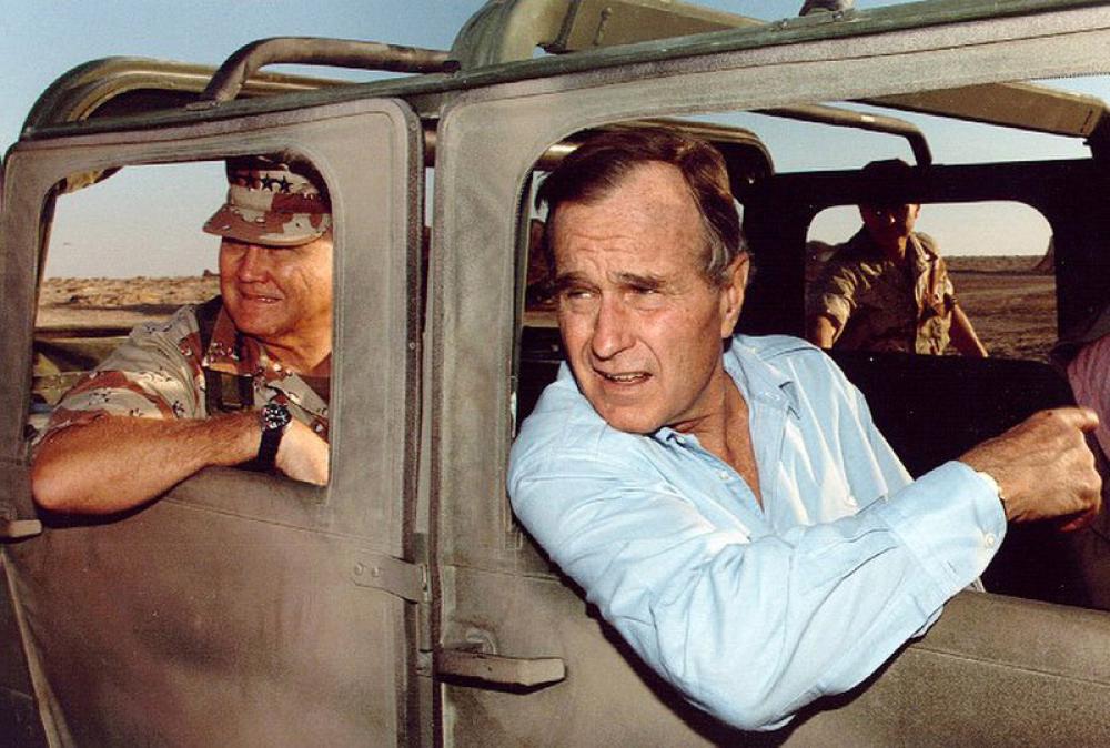 Norman Schwarzkopf, Jr. and President George H. W. Bush visiting troops during the Gulf War free photo Norman Schwarzkopf, Jr. and President George H. W. Bush visiting troops during the Gulf War free photo